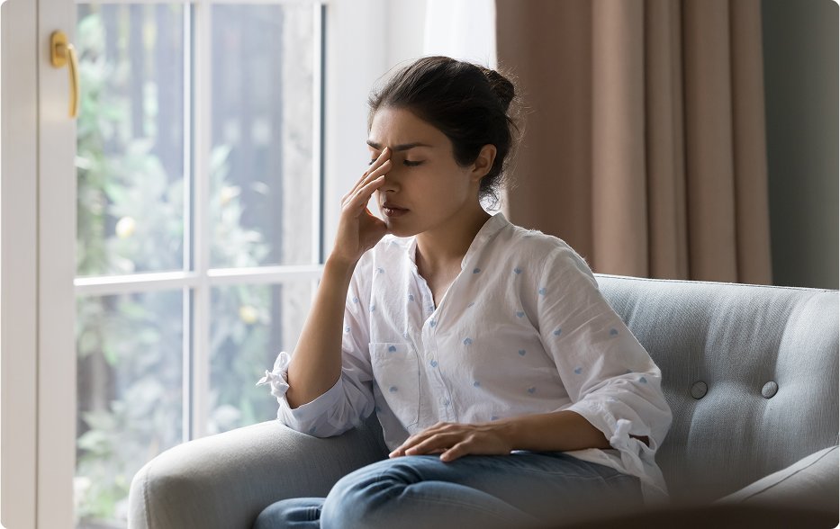 stock-photo-depressed-frustrated-young-indian-woman-suffering-from-headache-migraine-touching-face-head-with-2184679453 1